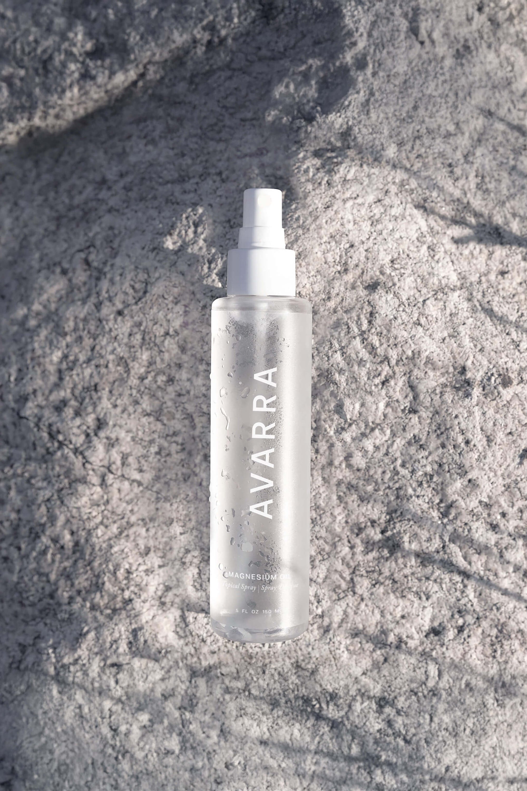 Avarra Magnesium Oil Spray bottle 150ml-on a grey rock